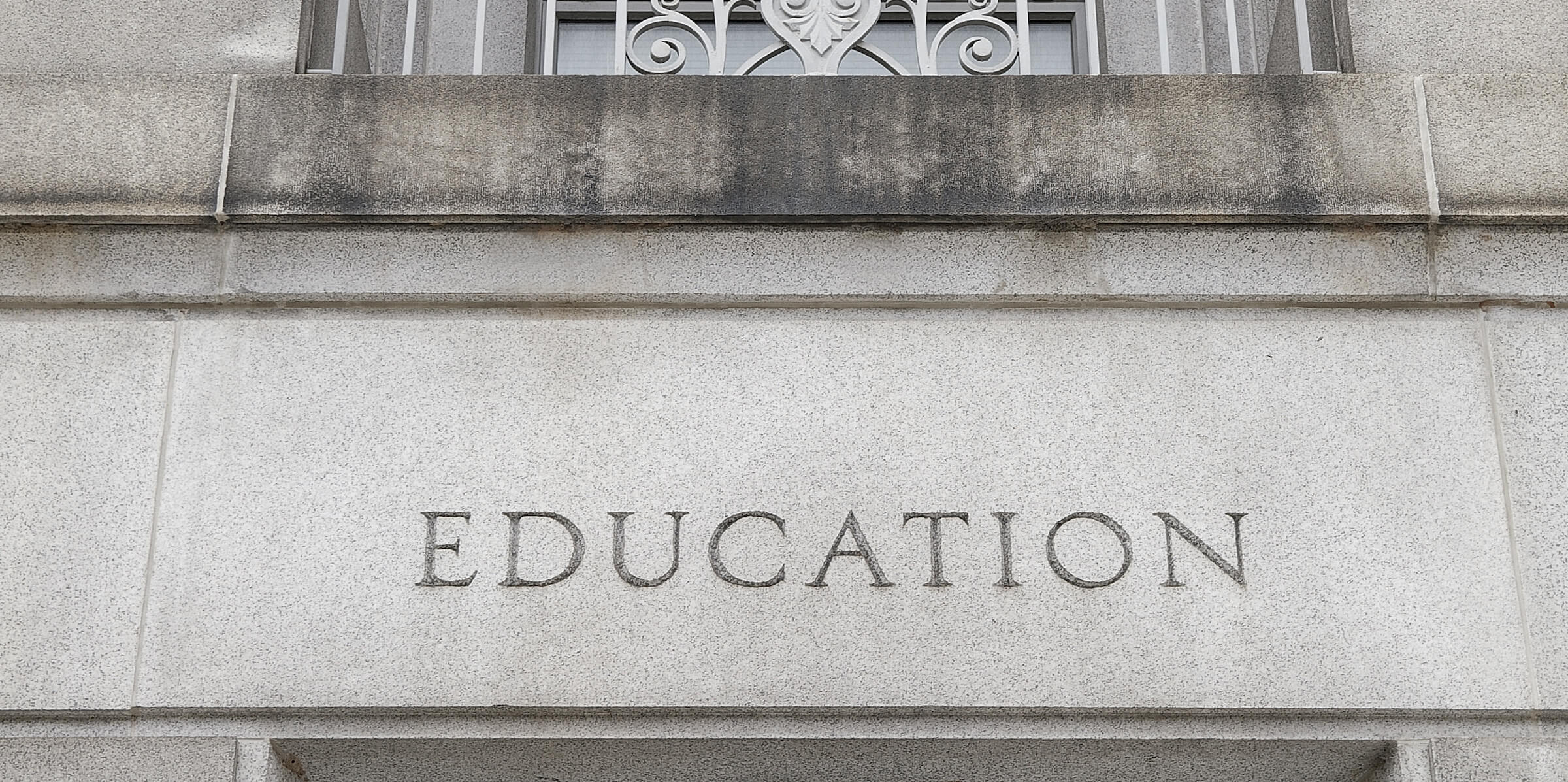 Closeup of the word education on a Camus building 