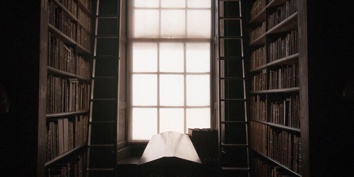 an open book on a stand in a dark library