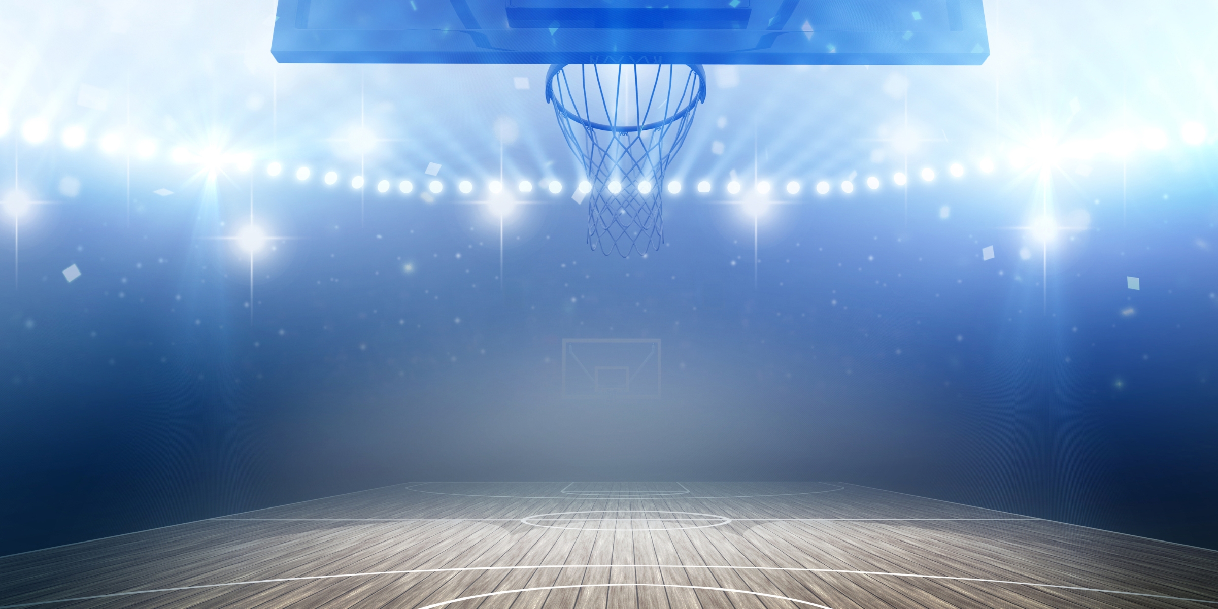 blue spotlights behind the net of an empty basketball court