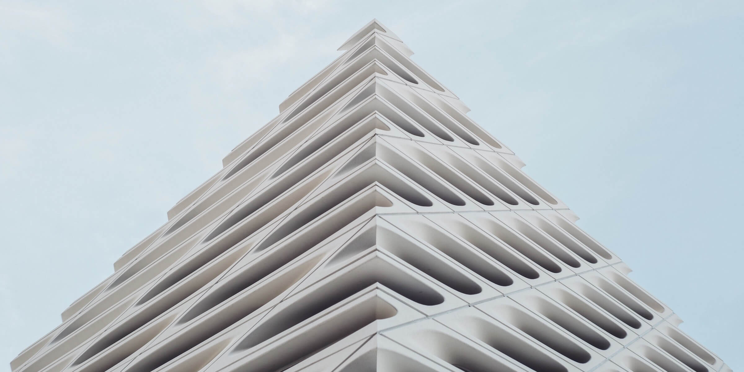 A building with a unique design, angled to the camera in the shape of a triangle