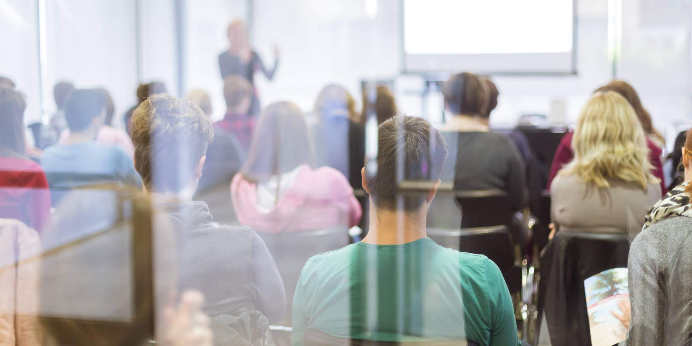 students facing a presenter in a classroom