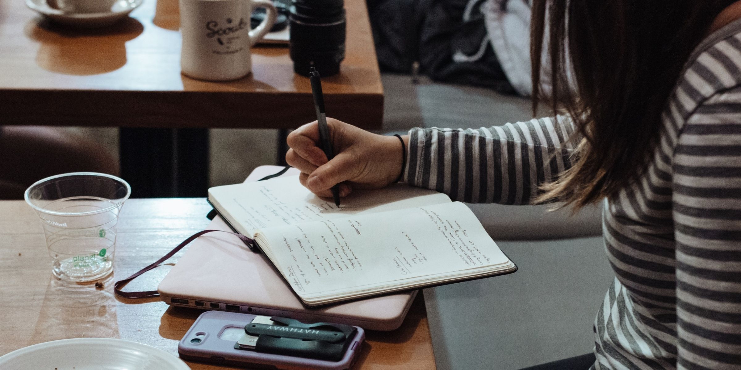 A student writing notes in a notebook