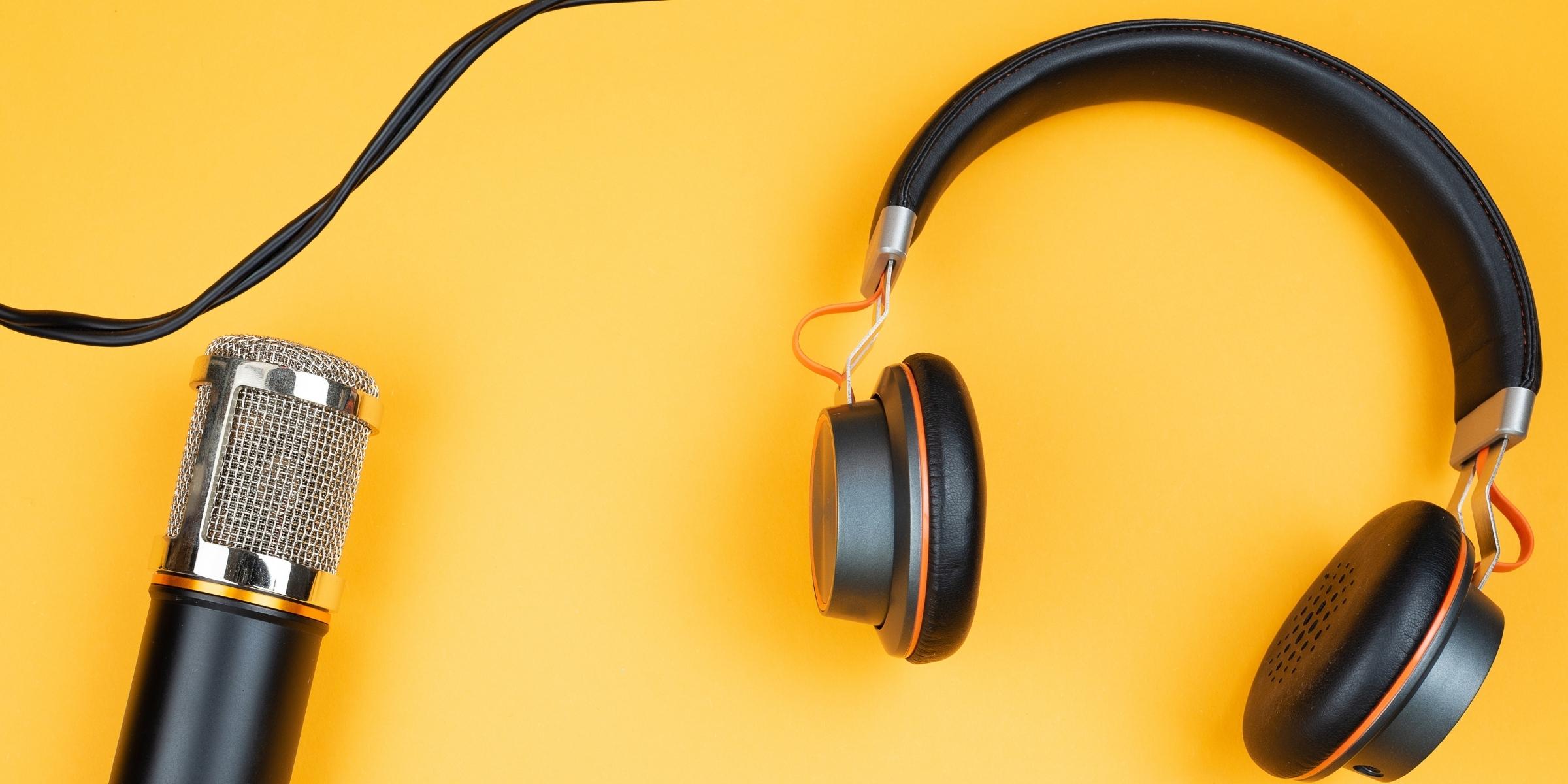 headphones and a microphone against a yellow backdrop