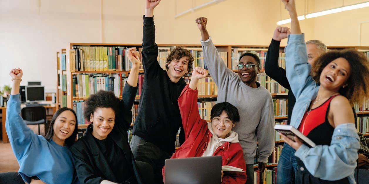 group-of-energic-students-raising-their-hands