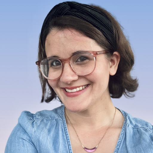 Jodi Tandet, Manager of Brand Content at Modern Campus, smiling in a denim top with glasses, representing higher education engagement and student success initiatives.