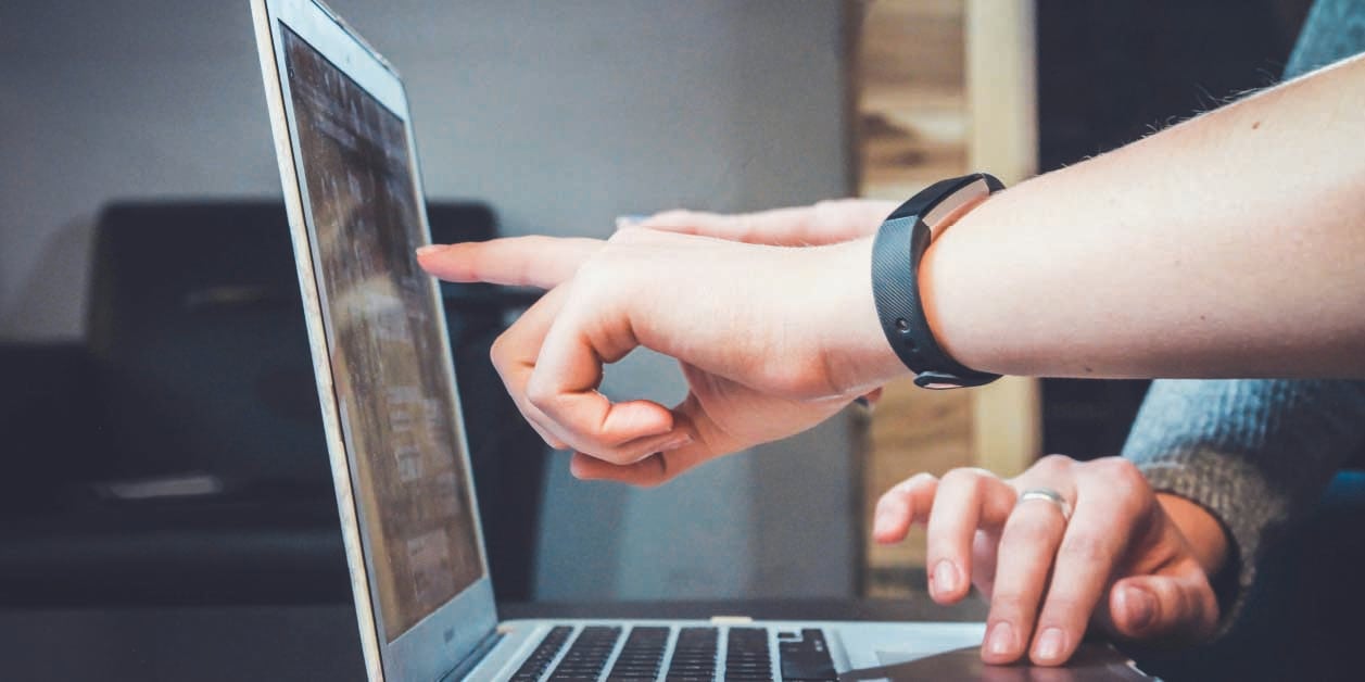 tudent-hands-pointing-to-a-laptop