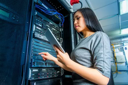 Woman holding ipad in a server room
