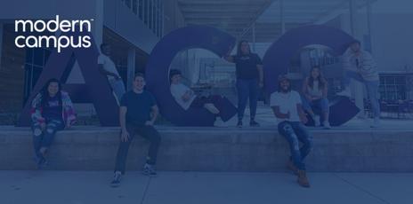 students smiling while sitting on giant letters spelling ACC